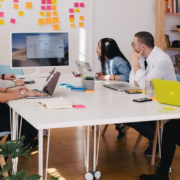 A team in an office discussing knowledge management strategy during a meeting