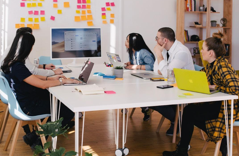 A team in an office discussing knowledge management strategy during a meeting